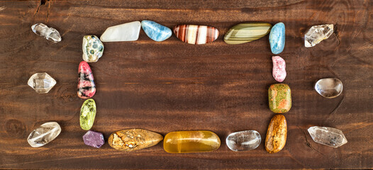 Colorful healing crystal stones, decoration gemstones. Alternative therapy banner or background with copy space.