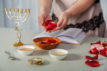 A Jewish woman does the rites before the wedding with rose petals and reads a blessing on her...