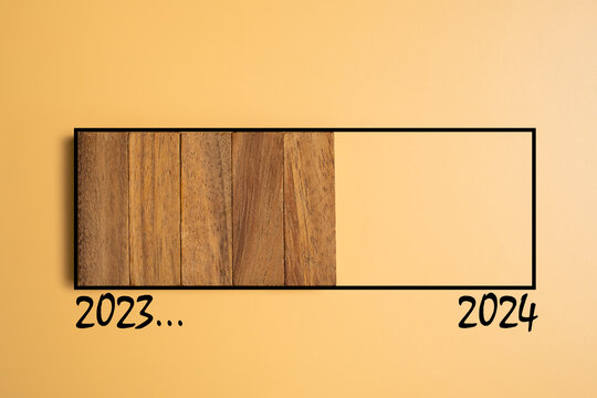 Wood brick as sign of developing progress from year 2023 going to new year 2024 with colored background. Count down to new year, half year business plan and strategy.