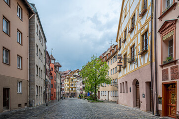 Fototapeta na wymiar Street with beautiful colorful half timbered houses In Nuremberg, Germany