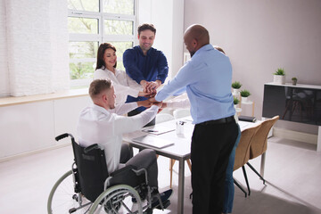 Obraz premium Businesspeople Stacking Their Hands Over Wooden