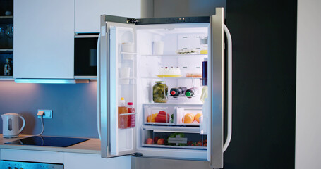 Open Refrigerator Full Of Juice And Fresh Vegetables