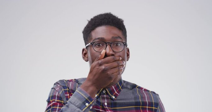 Black man in shock, surprise and wow face, emotion and wtf expression on white background. Mockup space, portrait with shocked male person in studio, reaction to announcement or news with drama