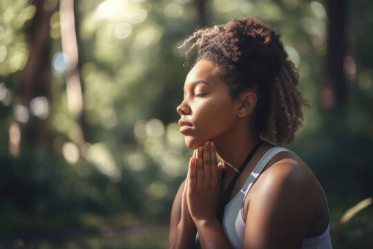 African American woman doing yoga with her hands clasped in front of her face in the morning in the park. Photorealistic illustration generative AI.