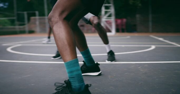 Closeup, legs and group with basketball, men and fitness with competition, workout goal and exercise. Zoom, male people or team with sports, ball and shoes on a court, teamwork and support with game