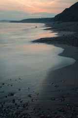 Long exposure shot of a coastline at sunset