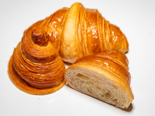Golden brown butter croissant with shadow isolated on the plain background.