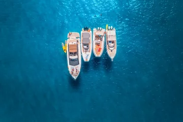 Foto op Plexiglas Aerial view of luxury yachts and boats on blue sea at sunset in summer. Travel in Sardinia, Italy. Drone view from above of speed boats, yachts, sea lagoon, transparent turquoise water. Seascape © den-belitsky