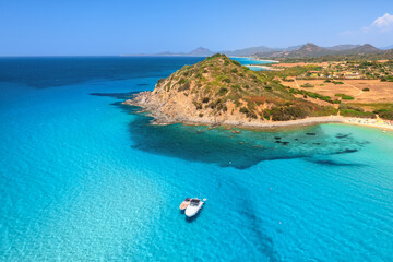 Aerial view of luxury yachts on blue sea at sunset in summer. Sardinia, Italy. Tropical seascape...
