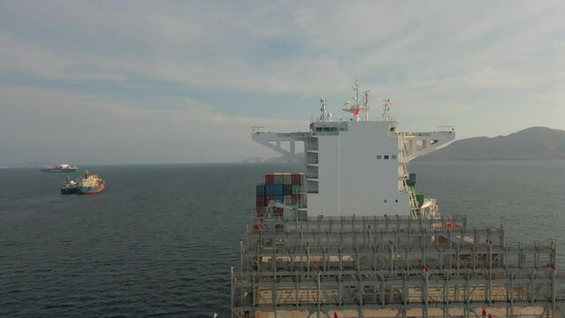 Aerial view of forward part and superstructure living area of ultra large container ship during anchorage 