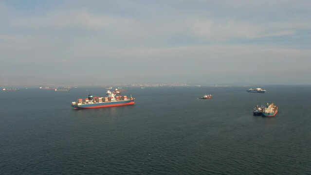 Callao, Lima, Peru -12.04.2022 Aerial view of Callao anchorage with large container ship and another vessels waiting for enter to the port