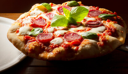 pizza with salami and tomatoes and mozzarella - 604399822