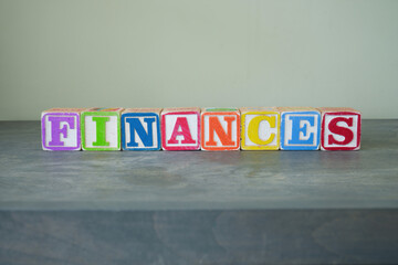 Toy wooden blocks spelling FINANCES