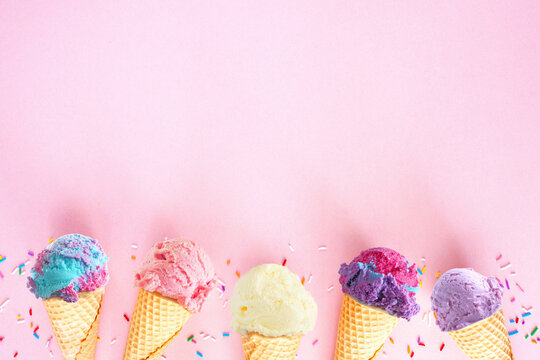 Ice cream bottom border over a pink background. Soft, pastel colors. Copy space.