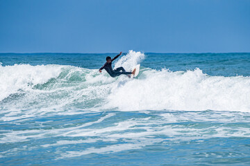 Surfer riding waves in Furadouro Beach