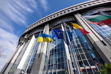 Ukrainian Flag, European Union Flag, Belgian Flag, Bulgarian Flag with daylight sky and building in background