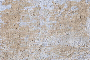 Textured old ochre-colored wall close-up