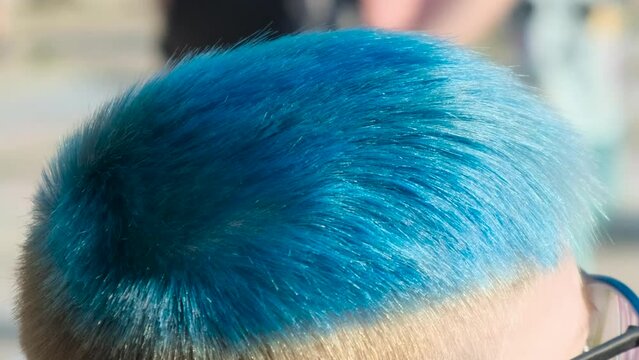 The boy's hair is dyed blue. Close-up