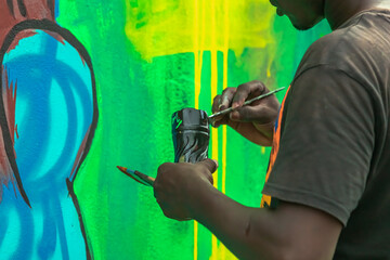 A young painter fearlessly expressing their individuality through their art, transforming a blank...
