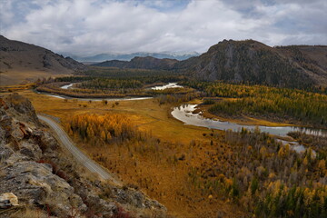 Fototapeta na wymiar Russia. The South of Western Siberia, the Altai Mountains. Amazing autumn view of the bends of the Chuya River near the North Chuya mountain range, popularly named as the Chuya snail.