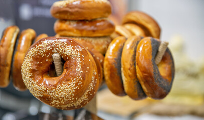 Freshly baked bagels with sesame and poppy seeds closeup.