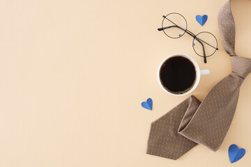 Happy Father's Day concept. Top view flat lay of necktie, cup of coffee, glasses and blue hearts on light beige background with blank space for text or promotion
