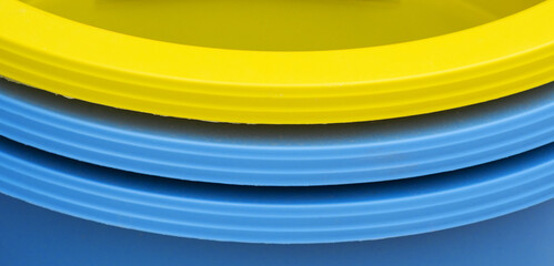sides of yellow and blue buckets
