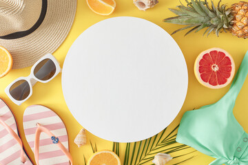Beach relaxation concept. Top view flat lay of swimsuit, sun-hat, flip flops, accessories, citrus and pineapple fruit, seashells and palm leaf on light yellow background with blank circle for text