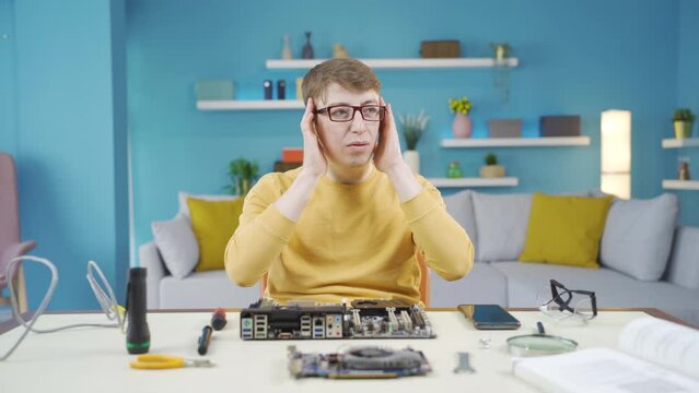 The young man is confused and cannot decipher the technology of the card.