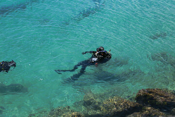 Divers on La Grava Beach on a sunny day