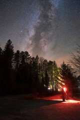 Milky Way Rising Over A Forest And Photographer