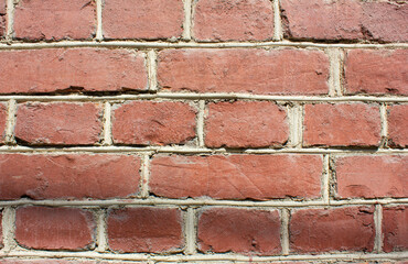 Vintage red brick wall.Dilapidated brick wall,background,texture. Faded ancient brick building.