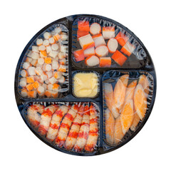 crab sticks surimi in black plastic tray with a film wrapper isolated on white background