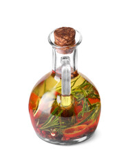Glass jug of cooking oil with spices and herbs isolated on white