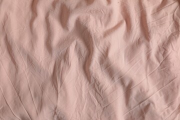 Crumpled pink fabric as background, top view