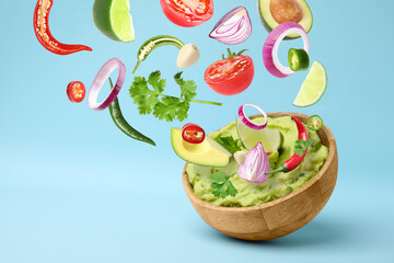 Delicious guacamole with flying ingredients on light blue background, space for text