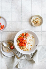 Homemade pellet with milk and strawberries. Prepared breakfast for the whole family in a ceramic plate. 