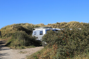 Fototapeta na wymiar An old caravan at a campsite