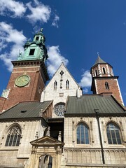 Old city center view with Adam Mickiewicz monument, St. Mary's Basilica and birds flying in Krakow on the morning