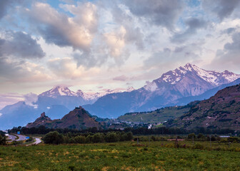 Alps mountain summer morning view with Castles Tourbillon and Montorge and snow covered rocky tops in far, Sion, Switzerland.