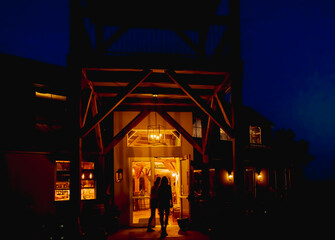 View of restaurant at night with two figures entering