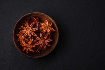 Star shaped spice star anise in a wooden round bowl