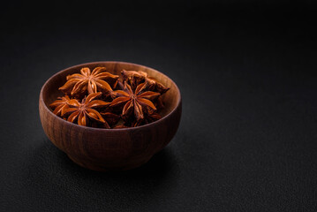 Star shaped spice star anise in a wooden round bowl
