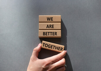 We are stronger together symbol. Wooden blocks with words We are stronger together. Businessman...