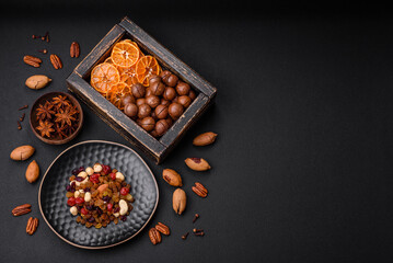 Obraz na płótnie Canvas Roasted pecans and macadamia nuts, dried tangerine, dried berries