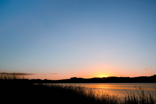Sunrise over calm river