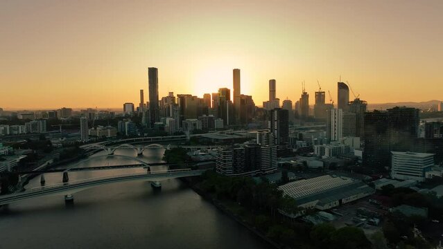 2023 - Excellent aerial footage approaching a Brisbane skyline at sunrise.