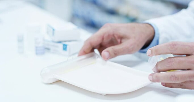 Pharmacy, hands and man counting pills on a tray for healthcare or drugs prescription. Male medical worker or pharmacist person with medicine product in hand for pharmaceutical service industry