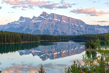 Rundle Mountain Peak Reflected in Calm Water of Two Jack Lake.  Scenic Canadian Rocky Mountains Springtime Landscape, Banff National Park