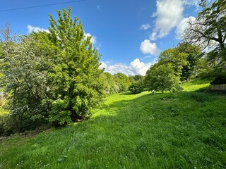 Rural landscape, with sloping fields, old trees, and broken cloud, on a spring day near, Norwood Green, Halifax, UK